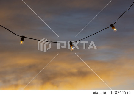 Outdoor party lights at sunset Outdoor party lights at sunset 128744550