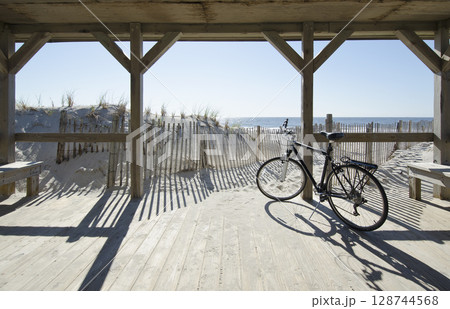 Bicycle by path to beach on sunny day 128744568