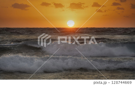 Sun rising over Atlantic Ocean Sun rising over Atlantic Ocean 128744669
