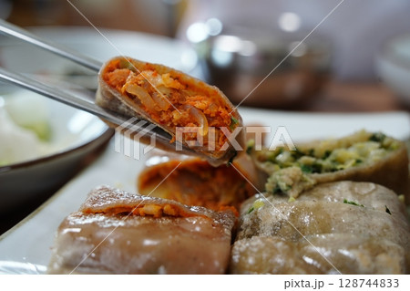 Korean Buckwheat Pancakes with Kimchi and Meat Fillings 128744833