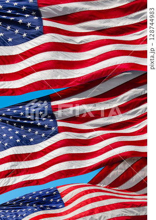 Three American flags blowing in wind 128744983