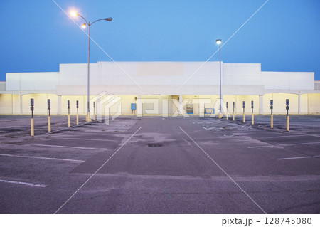Exterior of abandoned retail store at dusk 128745080