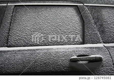 Close-up of car window and door covered with snow Close-up of car window and door covered with snow 128745081