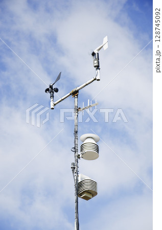 Weather monitoring station instruments against sky Weather monitoring station instruments against sky 128745092
