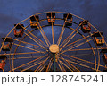 Low angle view of ferris wheel against sky at dusk 128745241