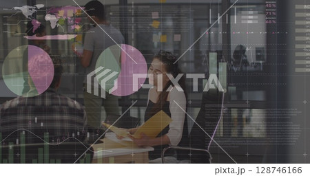 Statistical data processing against diverse male and female office colleagues discussing at office 128746166