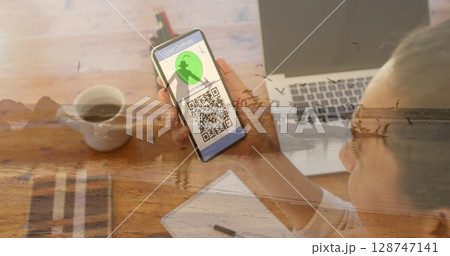 Image of caucasian woman with smartphone over caucasian woman at beach 128747141