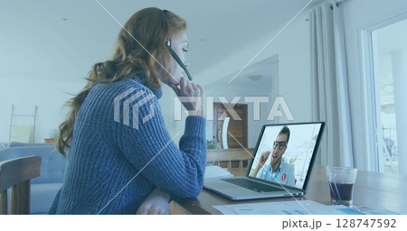 Image of thunder over caucasian woman having a image call on laptop at home Image of thunder over caucasian woman having a image call on laptop at home 128747592