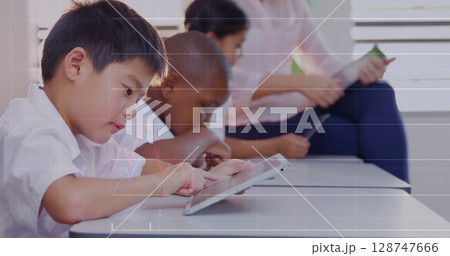Image of data processing over diverse schoolchildren using tablets in classroom 128747666