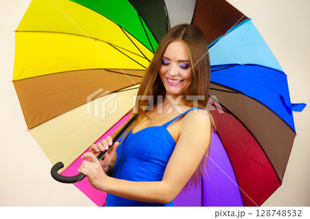 Woman in summer dress holds colorful umbrella 128748532