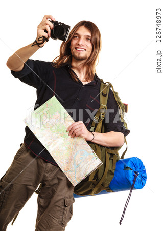 Man tourist backpacker taking photo with camera. 128748973
