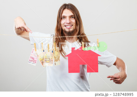 Man seller with money and house Man seller with money and house 128748995
