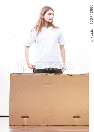 Delivery man holding a paper box. Delivery man holding a paper box. 128748996