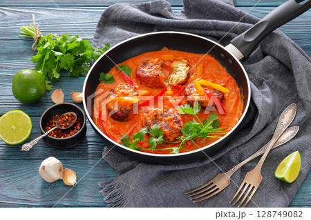fish cakes in tomato vegetable coconut milk sauce fish cakes in tomato vegetable coconut milk sauce 128749082