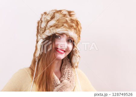 Winter woman in warm clothing fur cap Winter woman in warm clothing fur cap 128749526