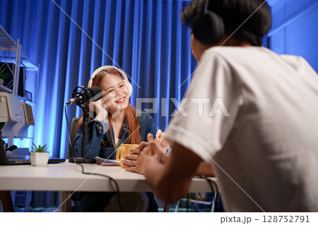 People in the podcast studio talking and recording People in the podcast studio talking and recording 128752791