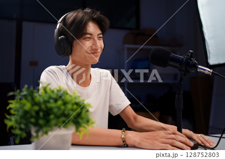 Female podcaster interviewing a guest in a recording studio Female podcaster interviewing a guest in a recording studio 128752803