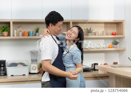 Couple Cooking Together in Modern Kitchen, Sharing Joyful Moments 128754066