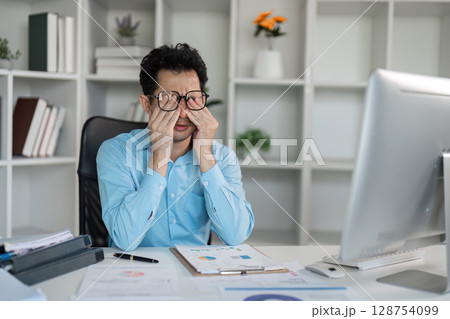 Tired professional overcomes hard work challenges at office desk detailed analysis business environment introspective viewpoint 128754099