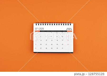 July 2026 Monthly desk calendar on orange color leather background. July 2026 Monthly desk calendar on orange color leather background. 128755120