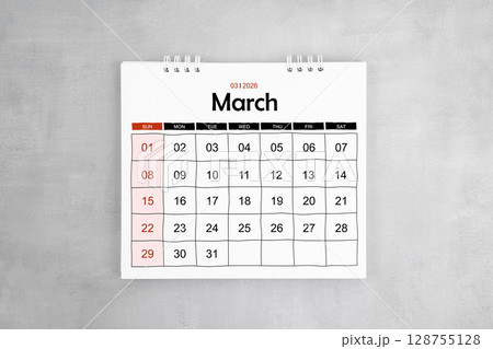 March 2026 desk calendar on gray cement wall background. Page of annual monthly calendar. 128755128