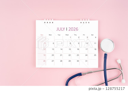 July 2026 desk calendar and stethoscope on pink background, Medical appointment concept. 128755217