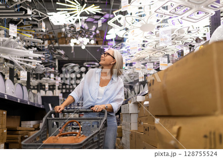 Shopping experience of a modern woman in a home goods store selecting items 128755524