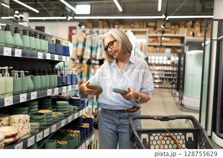 Modern commercial photoshoot featuring middle-aged woman shopping in a home improvement store Modern commercial photoshoot featuring middle-aged woman shopping in a home improvement store 128755629