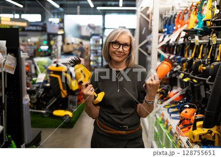 Choosing tools and products in a vibrant home improvement store setting Choosing tools and products in a vibrant home improvement store setting 128755651