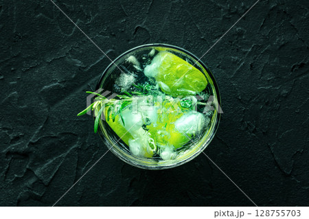 Gin tonic, overhead flat lay shot with rosemary and lime, fresh summer drink 128755703