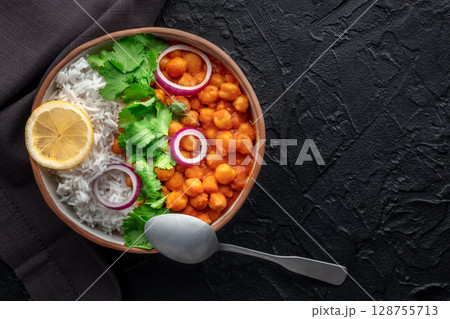 Chana masala, chickpea curry, traditional Indian dish, overhead flat lay shot Chana masala, chickpea curry, traditional Indian dish, overhead flat lay shot 128755713