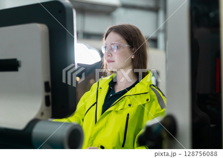 women engineer using computer control panel cnc machine at workshop. technician Female control automated machine process programming cnc machine at industry manufacturing. heavy industrial. women engineer using computer control panel cnc machine at workshop. technician Female control automated machine process programming cnc machine at industry manufacturing. heavy industrial. 128756088