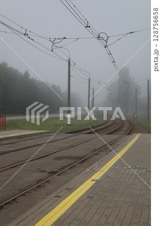 Railway, tramway, rails go into fog. Axial landscape 128756658