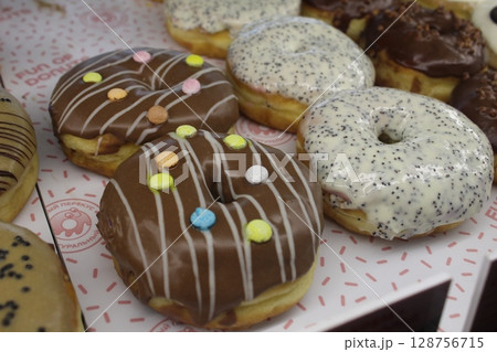 Donuts in colored chocolate glaze with sprinkles close-up. National food 128756715
