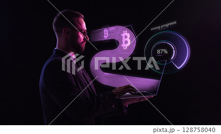 Business man with laptop tracking bitcoin mining progress in purple holographic UI 128758040