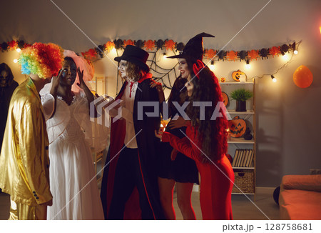 People view image and makeup of their female friend who is dressed as dead bride for Halloween. 128758681
