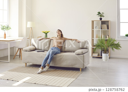 Calm woman relax on sofa taking nap 128758762