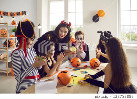 Teacher learn with kids dressed for Halloween eve 128758885