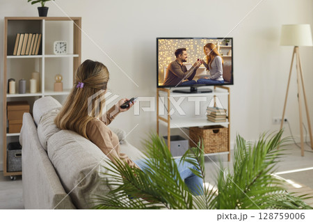 Young woman relax at home watching TV 128759006