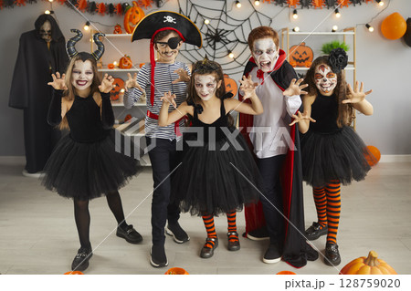 Portrait of group of children in creative costumes with scared faces at Halloween party. Portrait of group of children in creative costumes with scared faces at Halloween party. 128759020