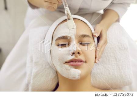 Young woman getting professional cosmetic facial treatment in spa or beauty salon Young woman getting professional cosmetic facial treatment in spa or beauty salon 128759072
