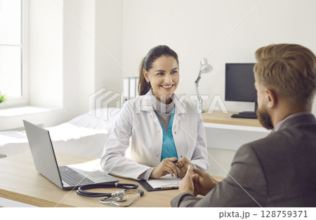 Smiling woman doctor have consultation with patient Smiling woman doctor have consultation with patient 128759371