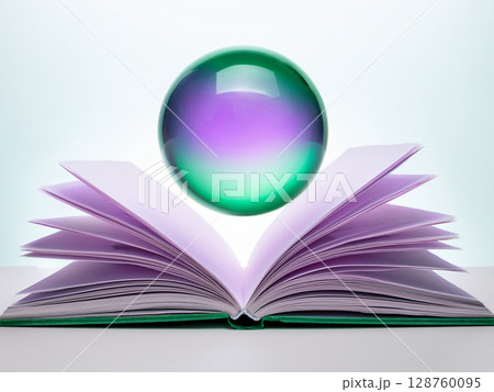開いた本の上に紫緑色の球が浮かんでいる 128760095