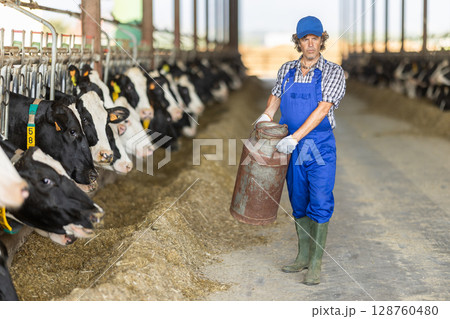 man holding a gas cylinder on a farm 128760480