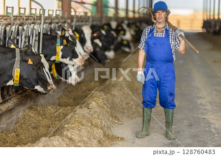 Male farmer working with rake 128760483