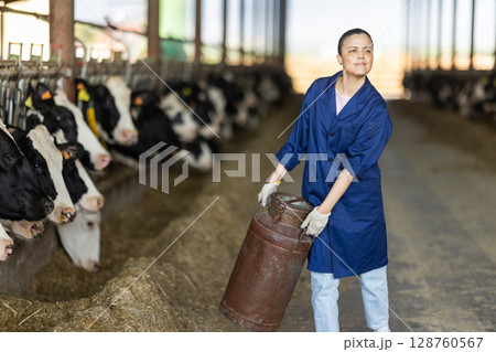 Asian woman employee with metal milk can 128760567