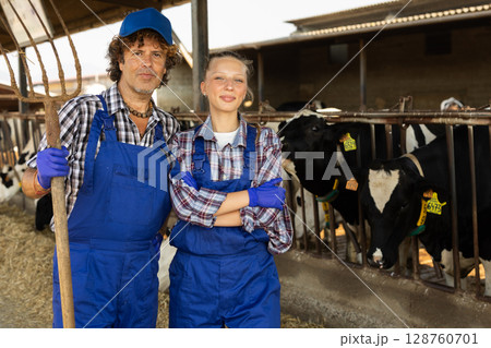 Young female and male farmers discussing something Young female and male farmers discussing something 128760701