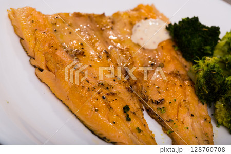 Dish of tasty steak of fried rainbow trout fillet with broccoli Dish of tasty steak of fried rainbow trout fillet with broccoli 128760708