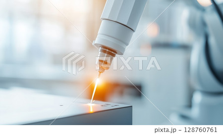 Welding station inside a manufacturing plant with robotic arms. 128760761