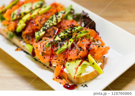 Image of salmon toast with lettuce, avocado and cheese Image of salmon toast with lettuce, avocado and cheese 128760860